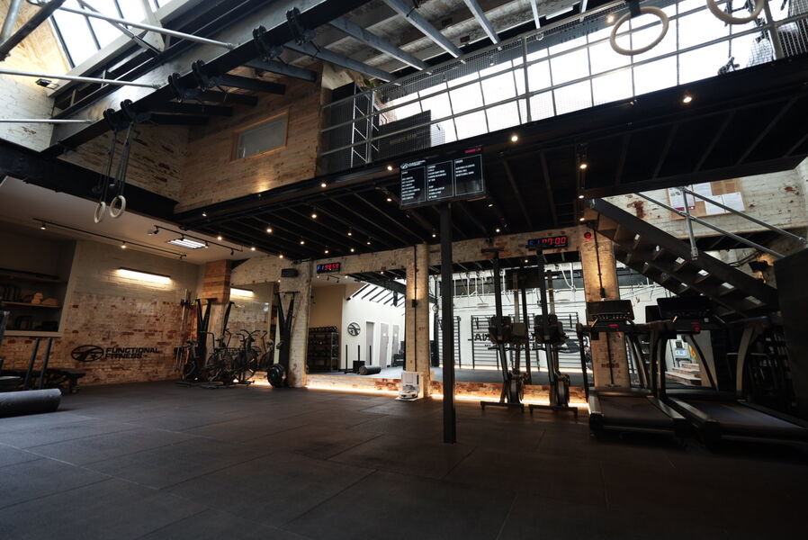 Functional Fitness gym interior in Farnham — exposed brick, skylight and calisthenics equipment