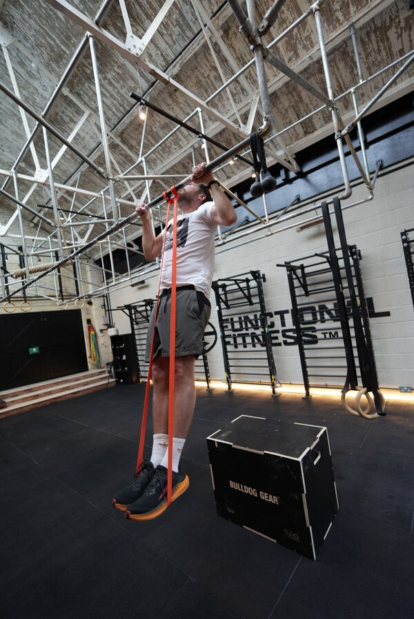 Banded pull-up at Farnham gym — beginner calisthenics progression